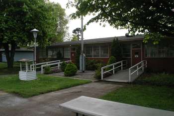 View showing both entrances to Orderly room and garden/flagpole